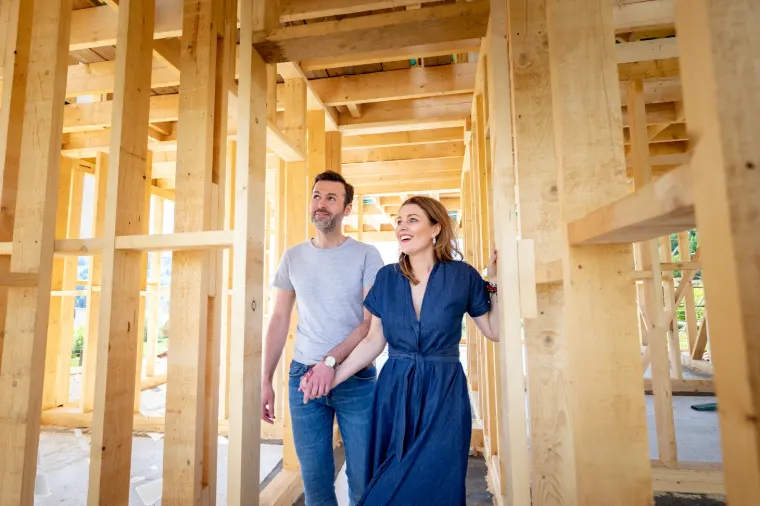 Couple walking through the framing of their custom home in Southwest Indiana