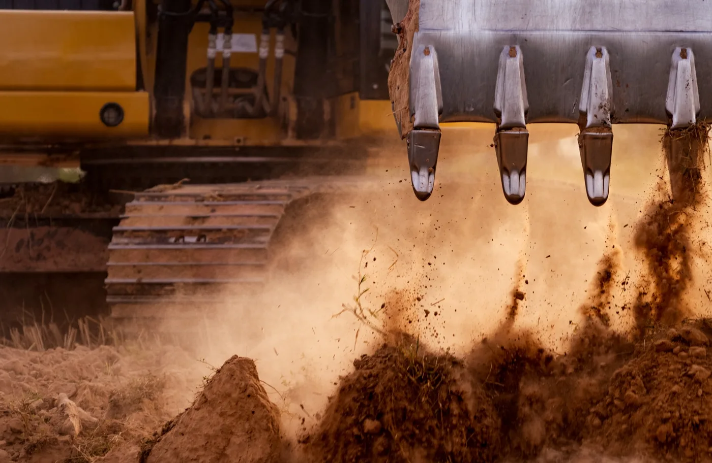 Excavator moving earth on a commercial construction site in Southwest Indiana