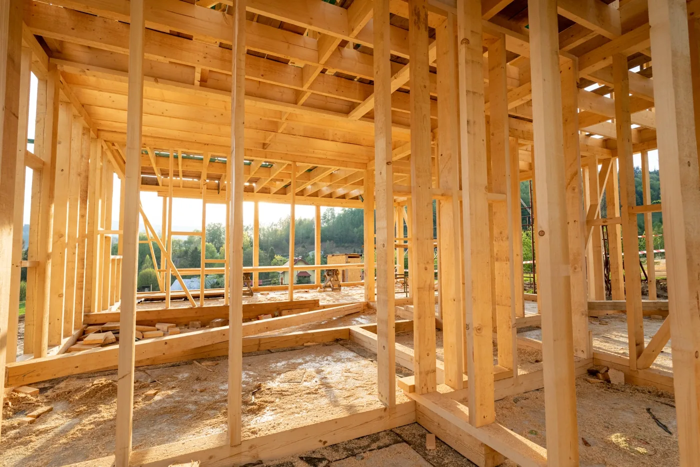 Sunlit interior framing of a custom home under construction