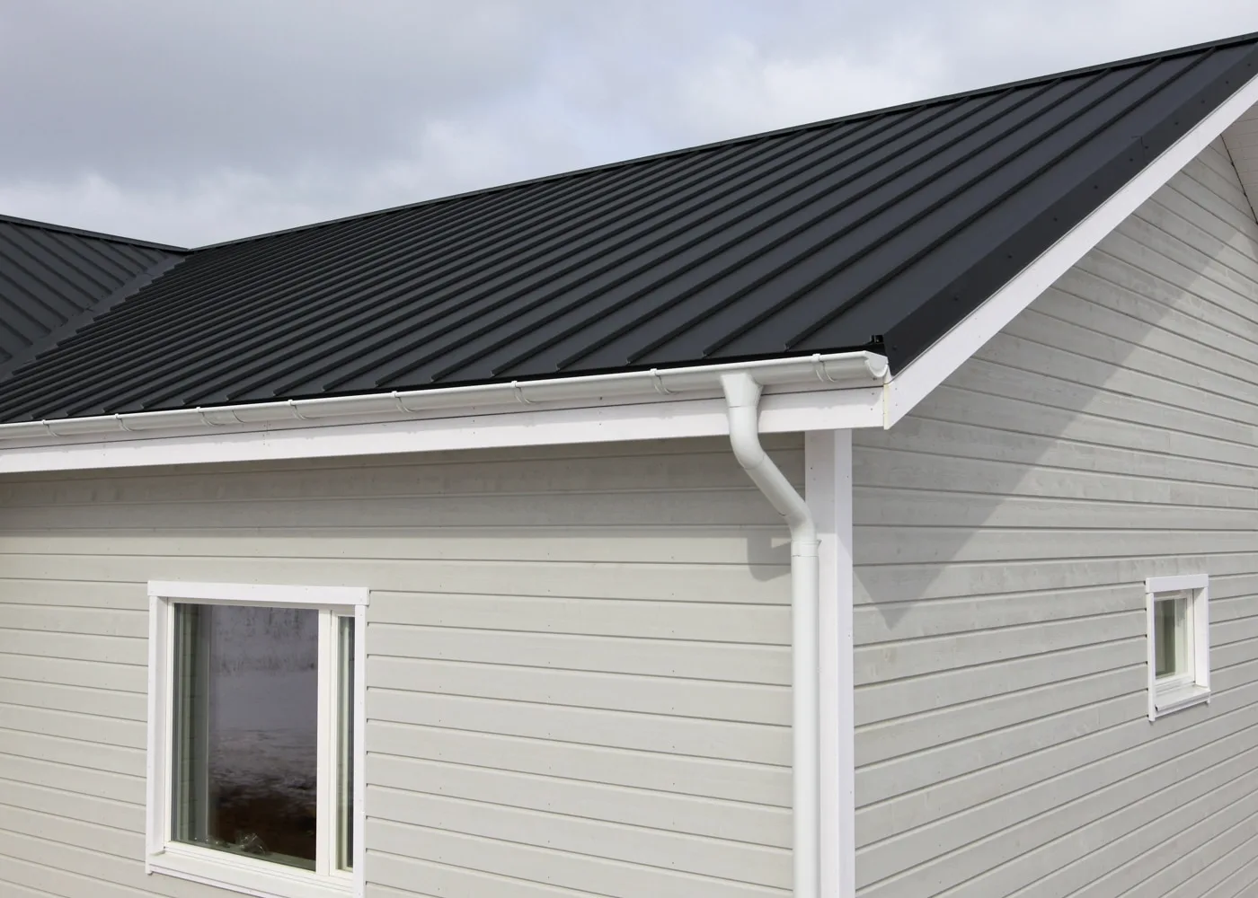 New white gutter and downspout installed on a Southwest Indiana home